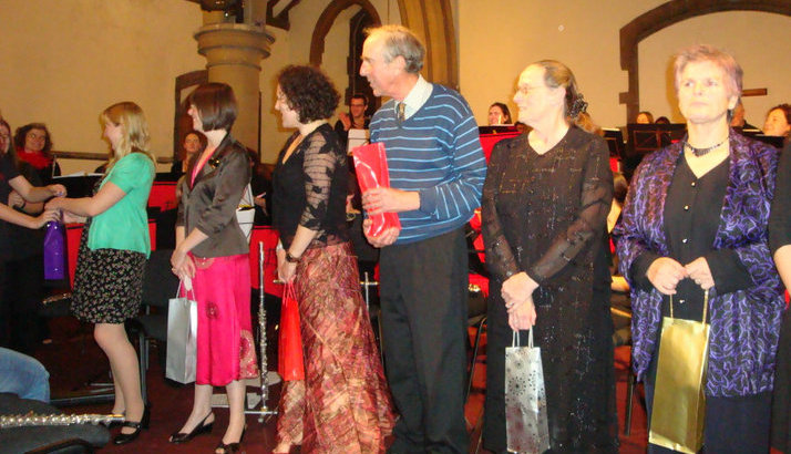 Musical directors being presented with gifts at the concert